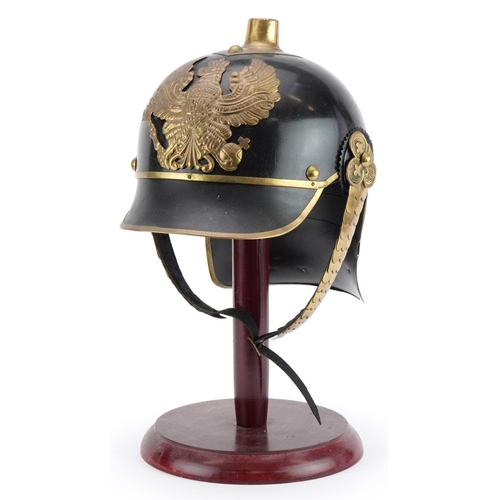 689 - German military interest re-enactment pickelhaube on hardwood stand, overall 39cm high