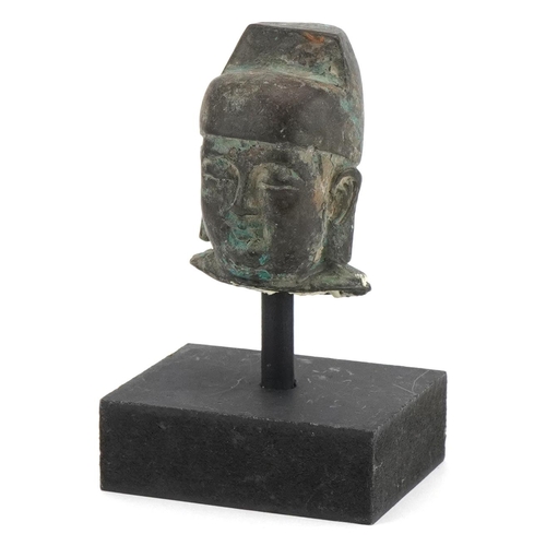 1743 - Chinese patinated bronze head of Buddha raised on a painted stand, overall 12.5cm high