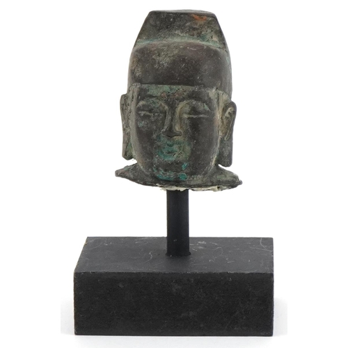 1743 - Chinese patinated bronze head of Buddha raised on a painted stand, overall 12.5cm high