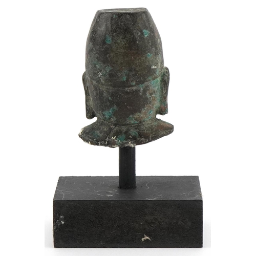 1743 - Chinese patinated bronze head of Buddha raised on a painted stand, overall 12.5cm high