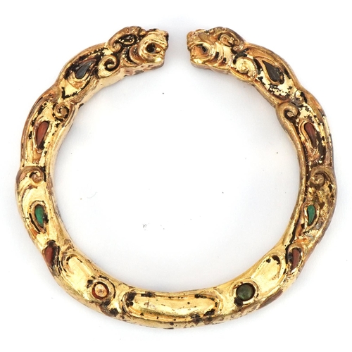 1739 - Tibetan gilt metal dragon bangle, 8cm wide