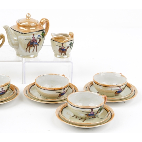 1645 - Childs lustre porcelain tea service decorated with deserts, the teapot 8cm high