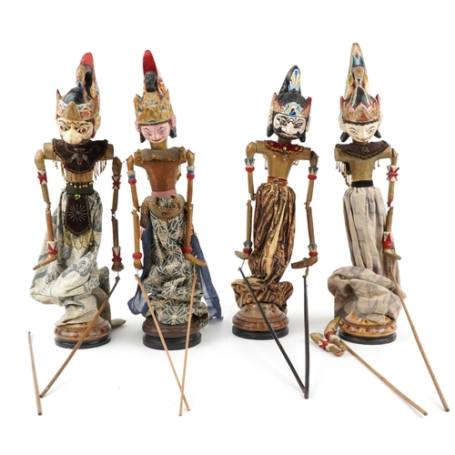 1548 - Four Indonesian hand painted wooden puppets from Java, each approximately 55cm high