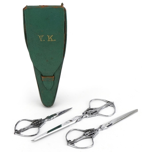 295 - Graduated set of three French 19th century cut steel scissors by Nogent of France, housed in a velve... 