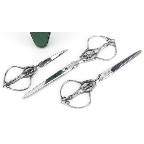 295 - Graduated set of three French 19th century cut steel scissors by Nogent of France, housed in a velve... 