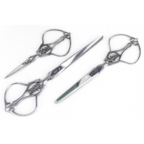 295 - Graduated set of three French 19th century cut steel scissors by Nogent of France, housed in a velve... 