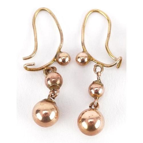 2164 - Two pairs of yellow metal earrings comprising clear stone studs and graduated ball drops, the larges... 