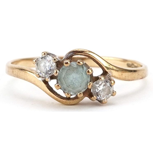 2192 - 9ct gold blue topaz and clear stone crossover ring, size M, 1.3g