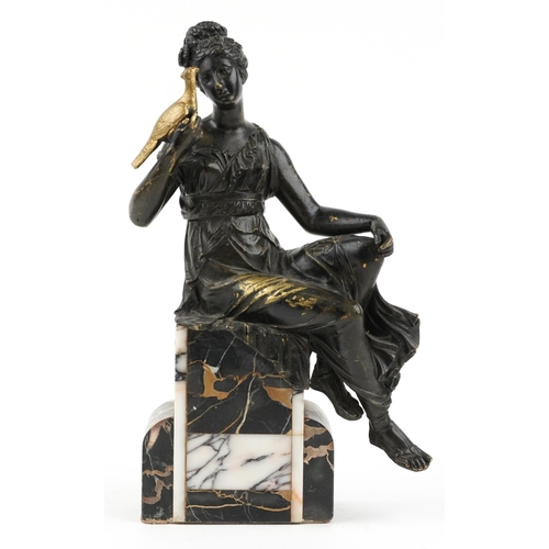 487 - Classical partially gilt patinated bronze figure of a female holding a bird raised on a marble base,... 