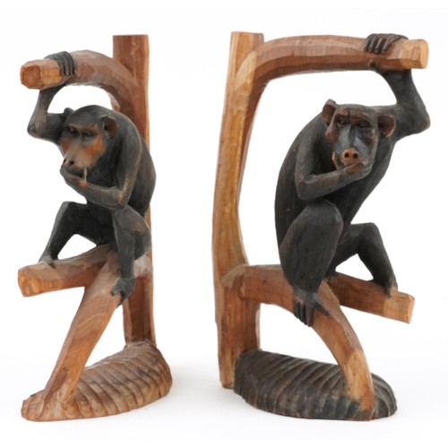 1569 - Pair of part stained wood carvings of monkeys on branches, each 30cm high