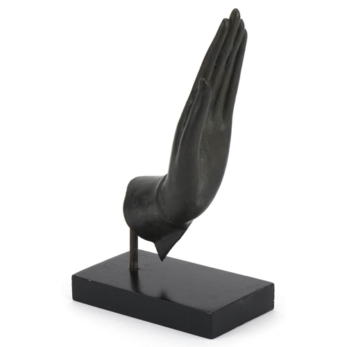 498 - Thai verdigris patinated bronze hand raised on an ebonised stand, overall 22cm high