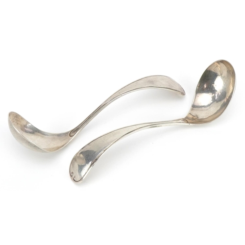 125 - Pair of Continental Arts & Crafts beaten silver ladles impressed Z to the handle, 17cm in length, 76... 