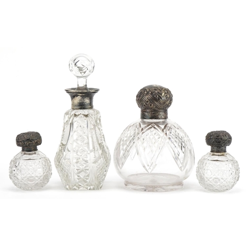 437 - Four Victorian and later cut glass scent bottles with silver lids and mounts, the largest 17cm high