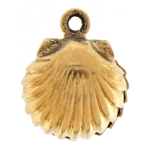 2180 - 9ct gold oyster charm opening to reveal a rotating pearl, 1cm wide, 1.8g