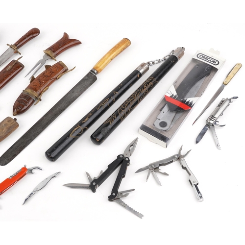 1803 - Vintage and later knives, folding pocket tools and a set of num-chuks including Swiss Army and Norwe... 