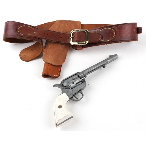 717 - Decorative model of an Inert Colt Peacemaker revolver with leather holster, the revolver 31cm in len... 