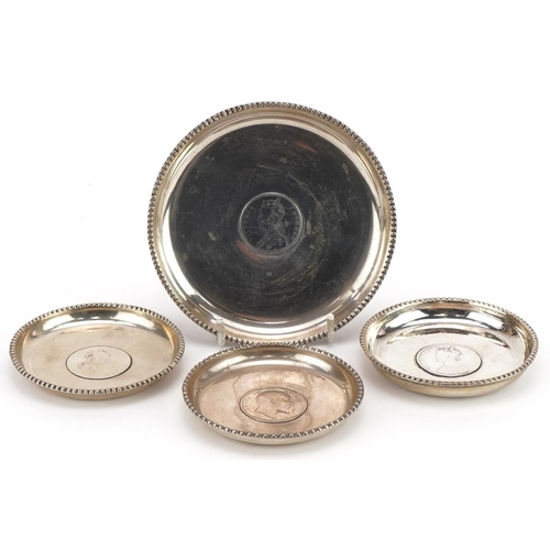 196 - Four 19th century Indian silver dishes, each inset with a rupee, comprising dates 1862, 1878, 1878 a... 