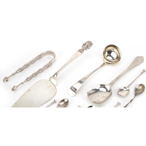 435 - Antique and later silver cutlery including a Thai cake slice, sugar tongs and ladle, the largest 23c... 