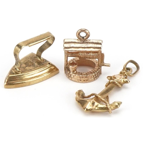 2145 - Three 9ct gold charms comprising anchor, wishing well and flat iron, the largest 1.9cm high, total 2... 