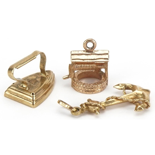 2145 - Three 9ct gold charms comprising anchor, wishing well and flat iron, the largest 1.9cm high, total 2... 