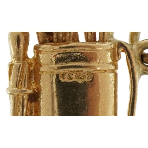 2112 - 9ct gold golf caddy and clubs charm, 2.5cm high, 3.9g