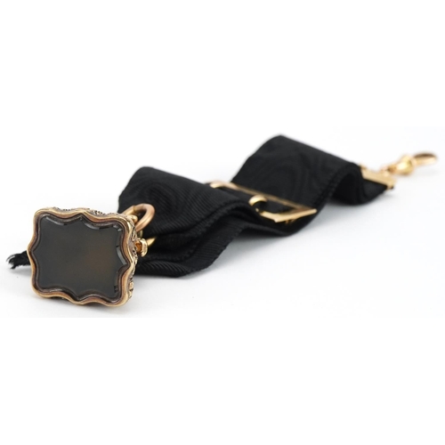 2073 - Victorian unmarked gold hardstone fob on a silk ribbon with 15ct gold mounts, overall 18cm in length... 