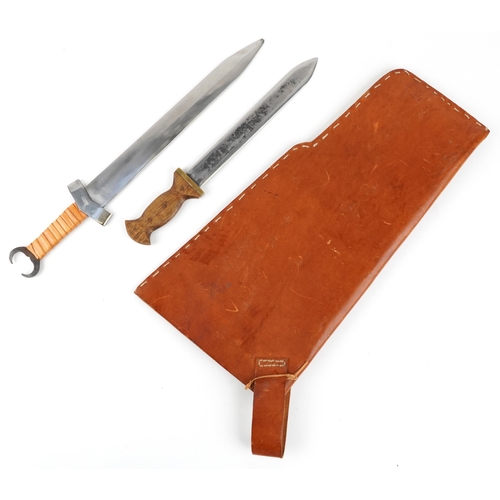 719 - Two re-enactment Celtic or Viking style short swords with leather sheath, the largest sword 59cm in ... 