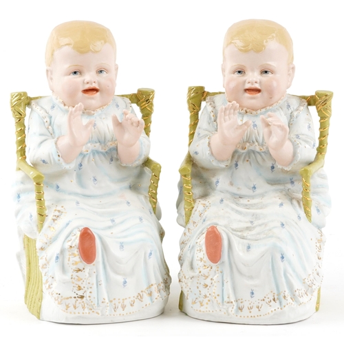 1731 - Pair of continental bisque porcelain figures of children in chairs, each 28cm high