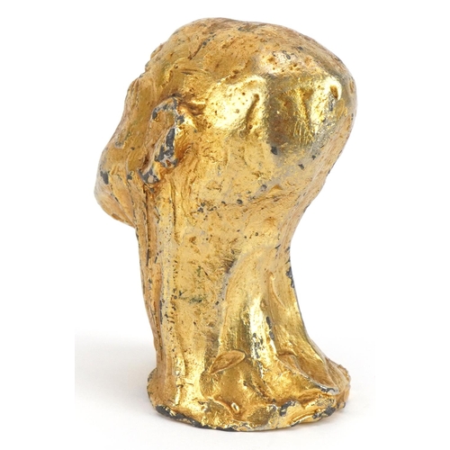 1624 - Manner of Salvador Dali, gilt painted cast metal sculpture of a man's head, 6cm high