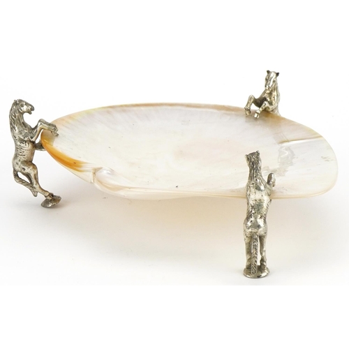 1478 - Mother of pearl dish raised on three silver plated mounts in the form of rearing horses, 19cm wide