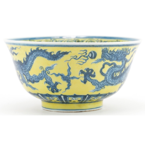 1628 - Chinese porcelain yellow ground bowl hand painted with dragons chasing the flaming pearl, six figure... 