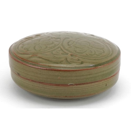 1519 - Korean porcelain bun box and cover having a celadon glaze, incised with flowers, 13cm in diameter