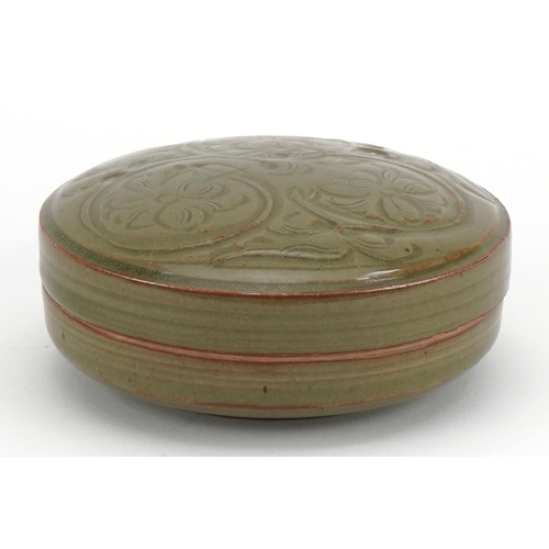 1519 - Korean porcelain bun box and cover having a celadon glaze, incised with flowers, 13cm in diameter