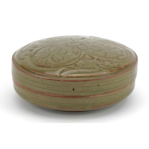 1519 - Korean porcelain bun box and cover having a celadon glaze, incised with flowers, 13cm in diameter