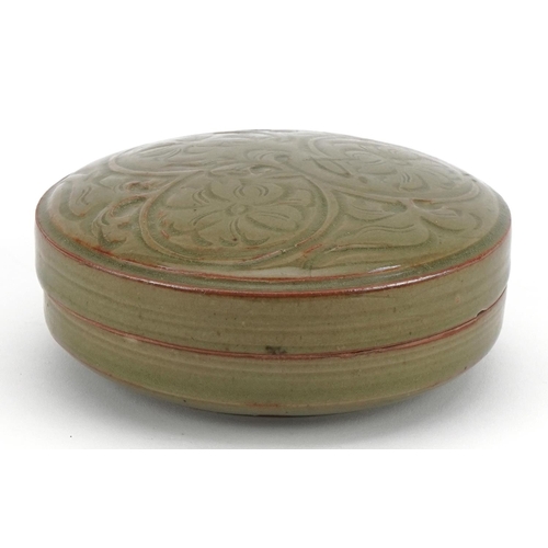 1519 - Korean porcelain bun box and cover having a celadon glaze, incised with flowers, 13cm in diameter