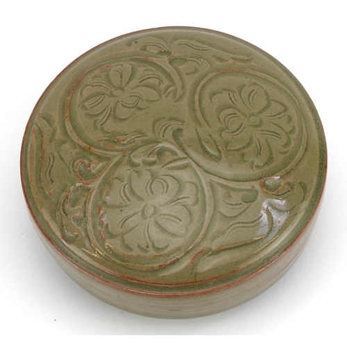 1519 - Korean porcelain bun box and cover having a celadon glaze, incised with flowers, 13cm in diameter