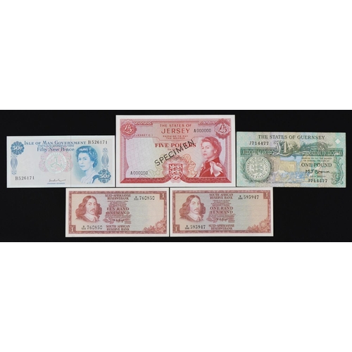 876 - Banknotes including States of Jersey five pound specimen note and States of Guernsey one pound