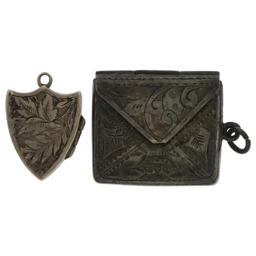 1617 - Edwardian silver stamp case in the form of an envelope and a silver shield shaped locket, the larges... 