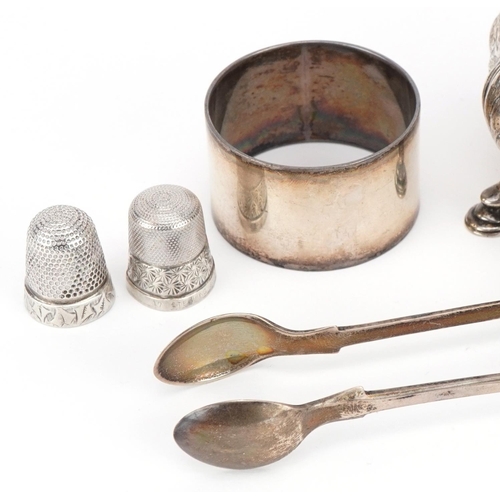 323 - Victorian and later silver objects including three footed salt, thimbles, napkin ring and sugar tong... 