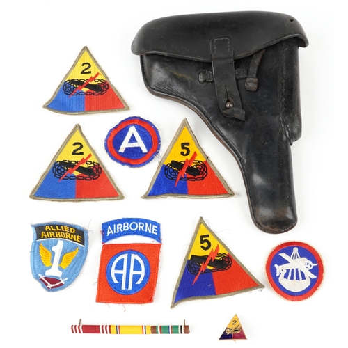 716 - German military P38 holster and various American cloth insignia, the holster 25cm in length