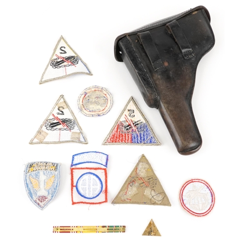 716 - German military P38 holster and various American cloth insignia, the holster 25cm in length