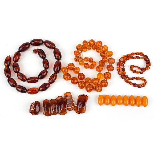 2547 - Amber coloured jewellery comprising three necklaces, bracelet and loose beads, total 222.0g