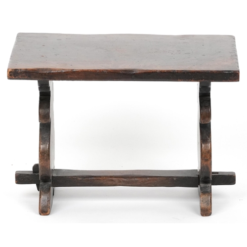 1157 - Carved oak refectory style stool carved with two wine goblets, 30cm H x 43cm W x 30cm D