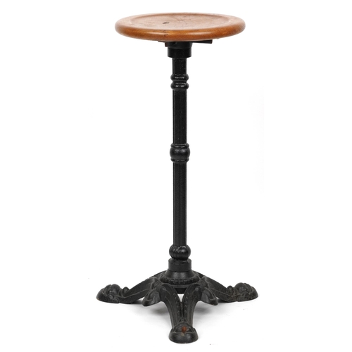 1074 - Industrial cast iron and oak circular occasional table, 74cm high x 31cm in diameter