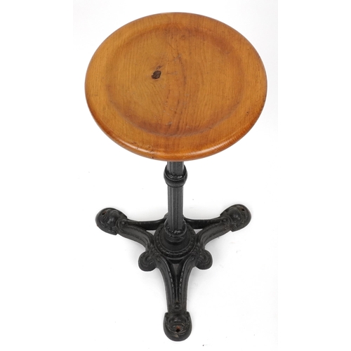 1074 - Industrial cast iron and oak circular occasional table, 74cm high x 31cm in diameter