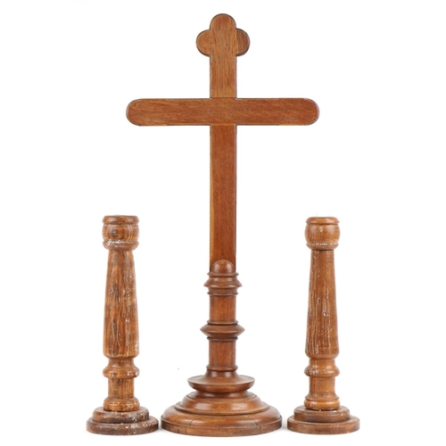 1370 - Carved oak altar cross and pair of turned candlesticks, the largest 77cm high