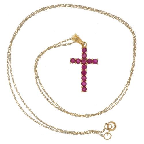 2109 - 9ct gold ruby cross pendant on a 9ct gold necklace, 2.5cm high and 44cm in length, 1.3g