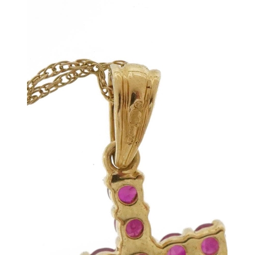 2109 - 9ct gold ruby cross pendant on a 9ct gold necklace, 2.5cm high and 44cm in length, 1.3g