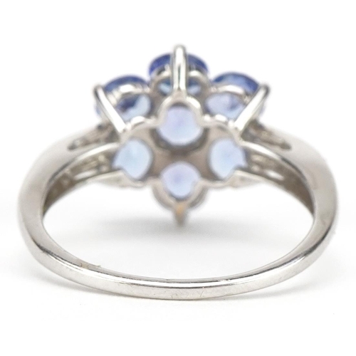 2137 - 9ct white gold tanzanite flower head ring with diamond set shoulders, size P, 3.3g