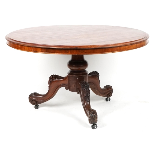 1083 - Victorian mahogany tilt top tripod table carved with flowers having circular top, 90cm high x 123cm ... 